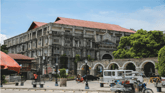 Duolingo: Speak about the Photo: Practice questions: A Grey Colonial Building