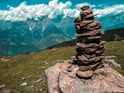 Duolingo write about the photo: A Cairn in a Majestic Mountain Landscape
