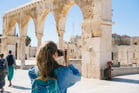 Duolingo Write About the Photo: Ancient Ruins and Curious Tourists