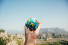 Duolingo Write About the Photo: A Globe in Hand – A Traveller’s Perspective